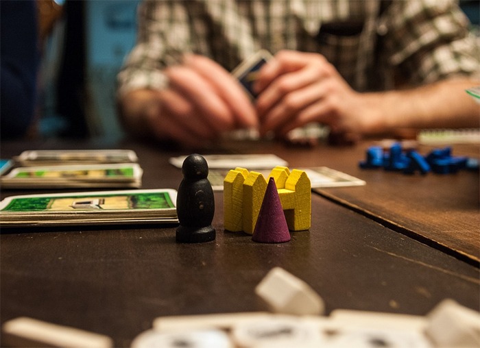 board game, dices, cards, a man holding a card