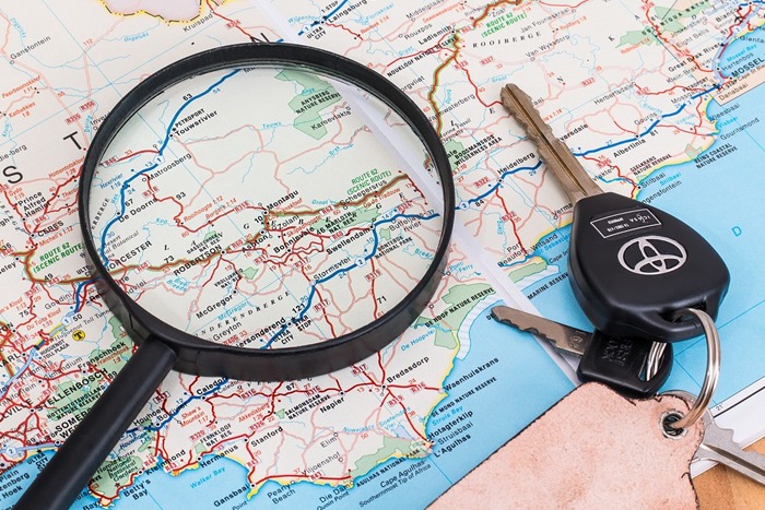 map, car keys, magnifying glass
