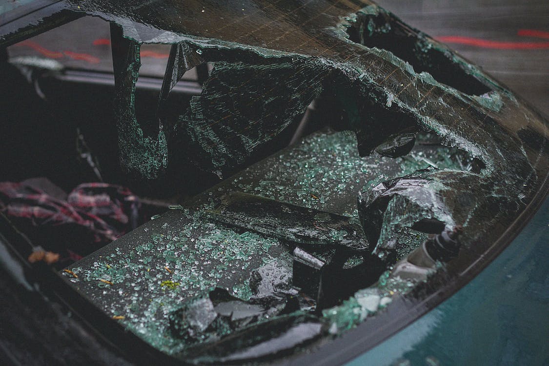 a close up of a car’s broken windshield