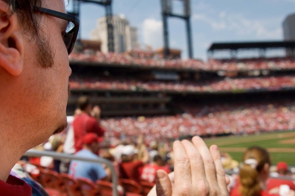 a-man-watching-a-baseball-game-live