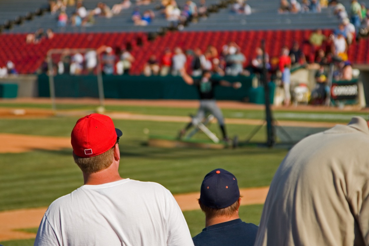 two-men-close-to-the-baseball-field-to-watch-a-game