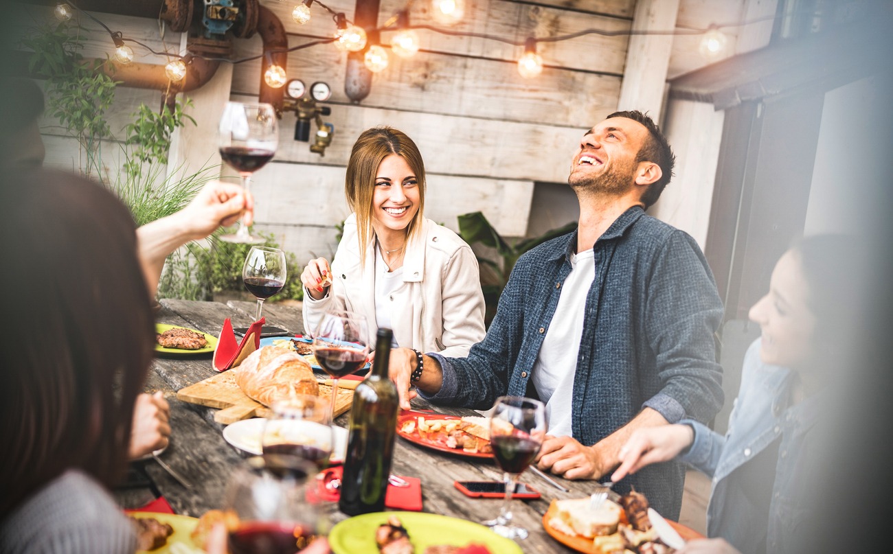 young-friends-having-fun-drinking-red-wine-on-balcony-at-house-dinner-party-happy
