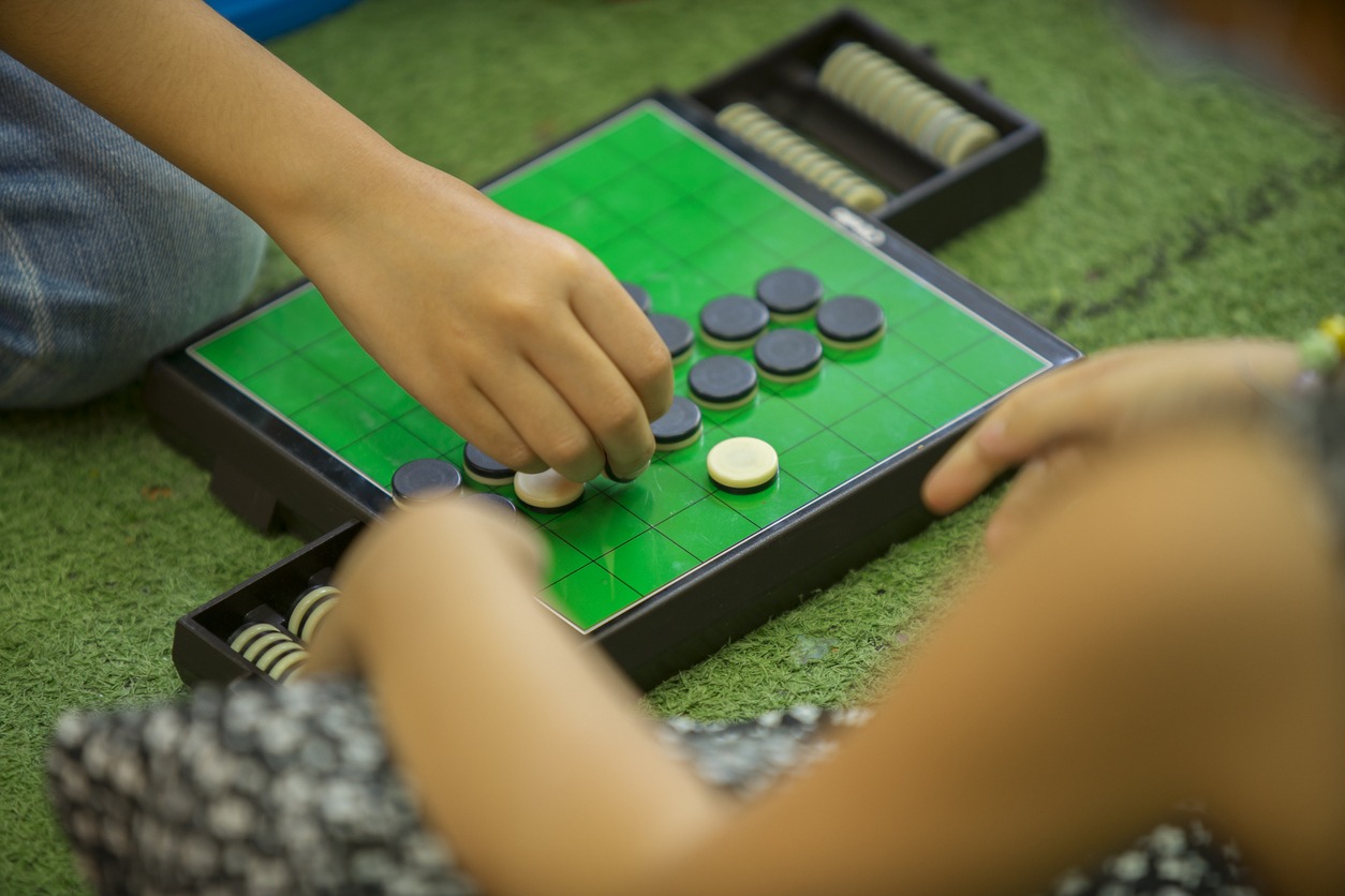 Child Is Playing Reversi Game