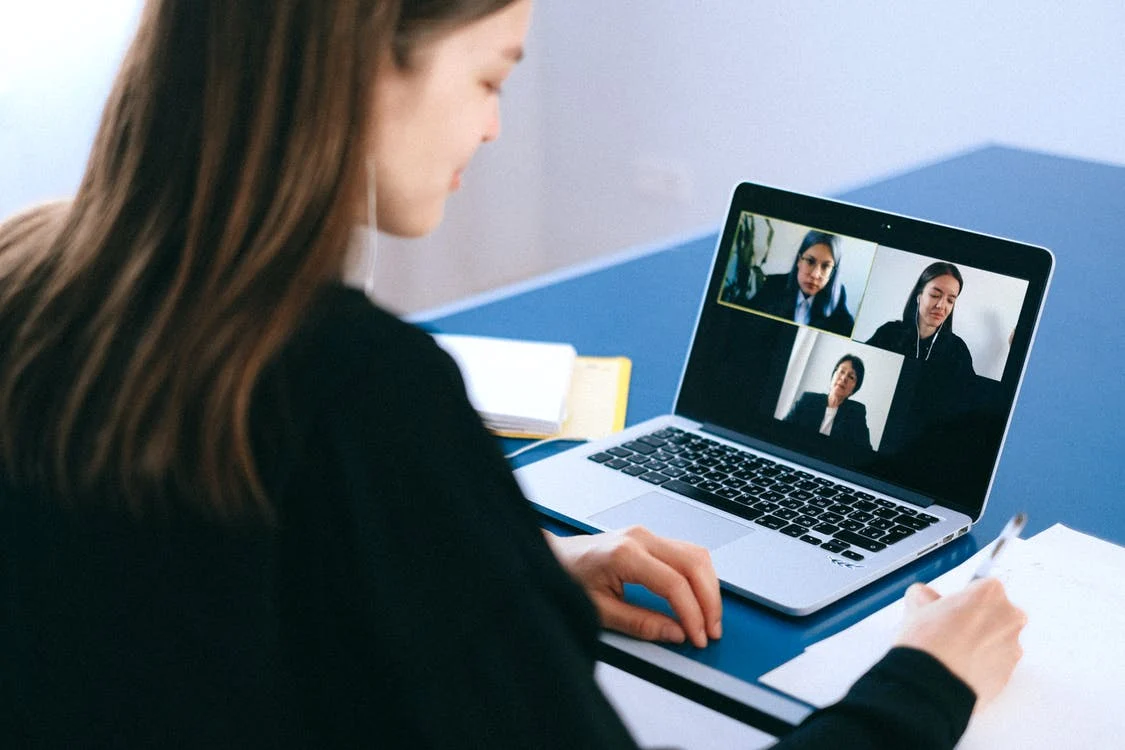 a woman on a video conference with others