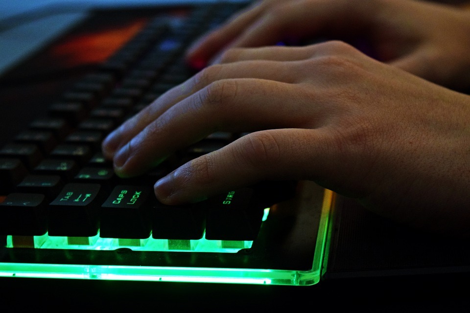 a close up of a person’s hand typing on a keyboard