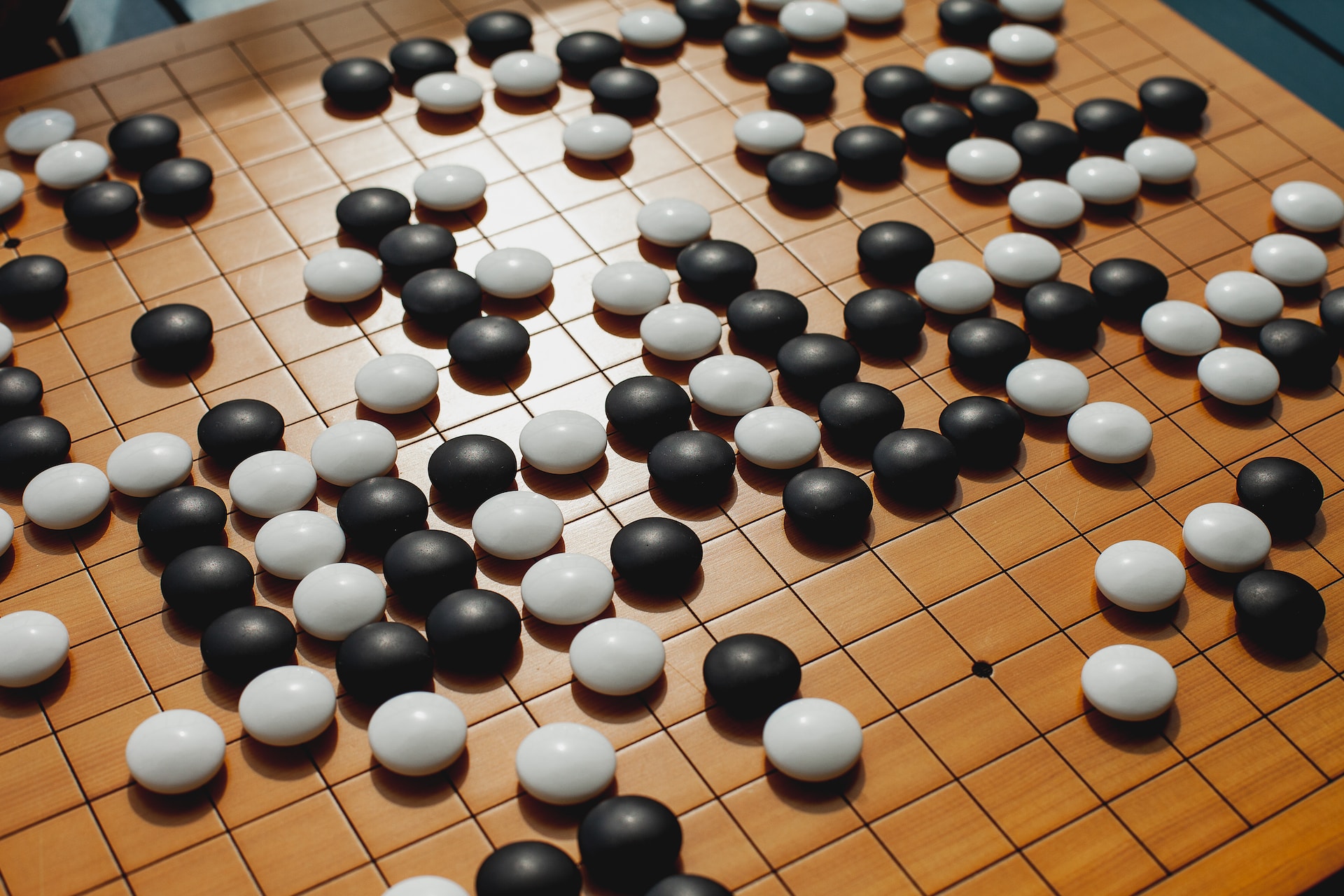 A close of a board game with black and white balls