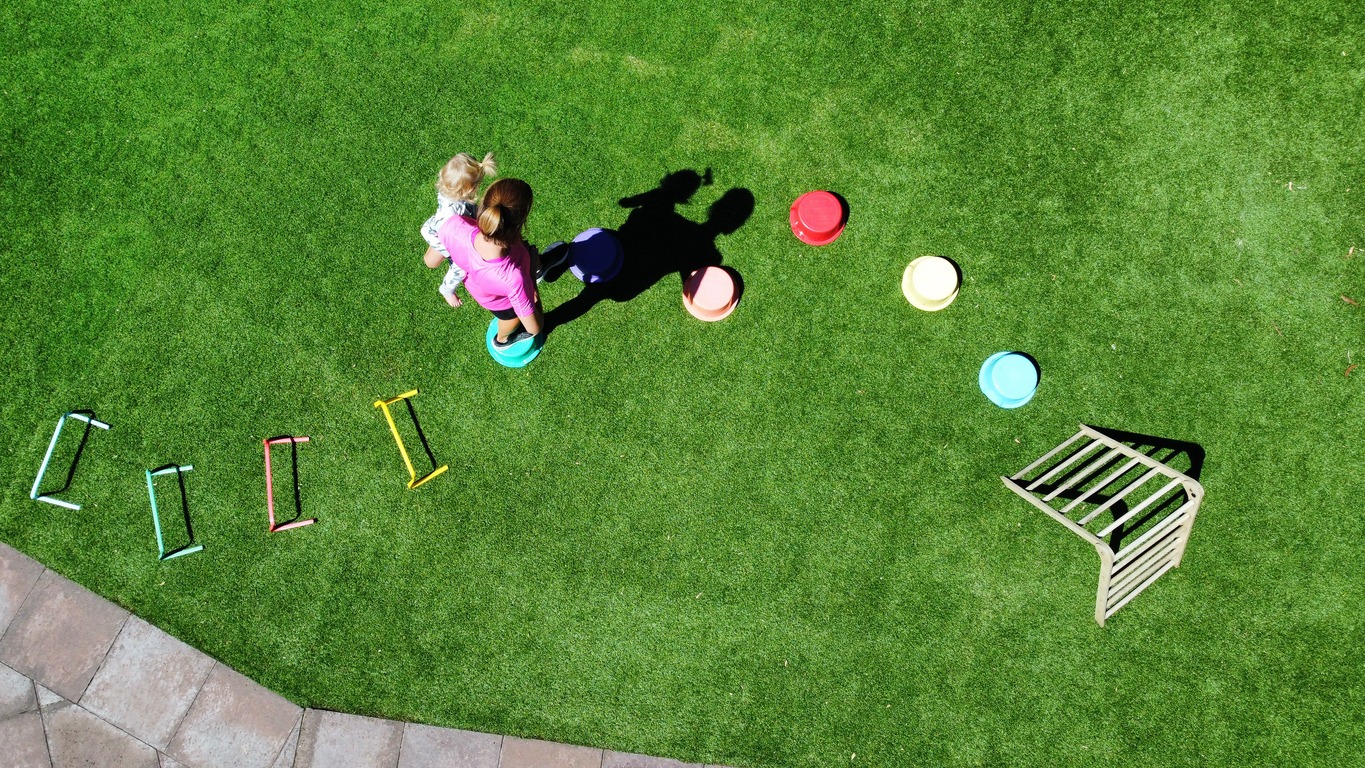 children playing obstacle course on the grass